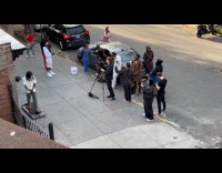 Crew filming music video with man walking on treadmill 