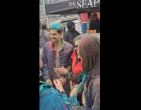 Friends rub colored powder to guy event