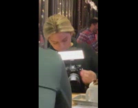 Woman fixes her light mounted on the camera