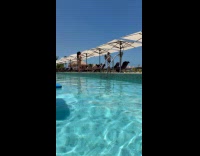 Woman directs man for her poolside video