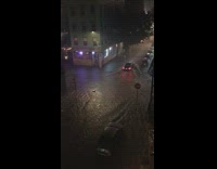 Car in flooded intersection after storm