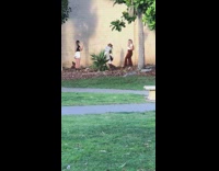 Girl brown pants park wall dried leaves