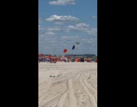 Dust devil makes beach umbrellas fly