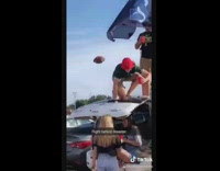 Guy closes trunk door on girl tailgate 