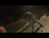 Guy in green shirt cracks beer over head and chugs beer 