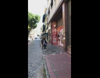 Woman in black sports bra tiktok dance on the sidewalk