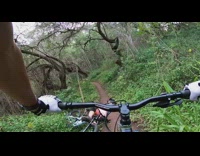 POV mountain biker falls on dirt road and lays on the trail