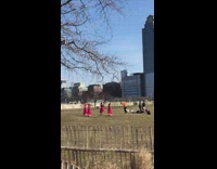 Four girls wearing matching red dresses dance 