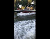 guy in green jet ski flips backwards