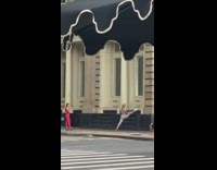 Girl does splits against side of building 
