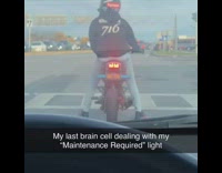 Guy waiting at red light dances motorcycle 
