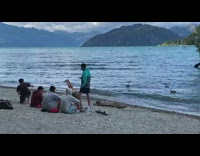 Guy lays on beach for photo