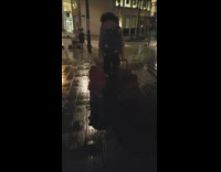 Kid hangs on the luggage that is pulled by a woman