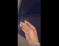 Guy holding corndog inside car loses corndog out window