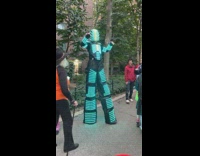 Person in flashing LED costume on street