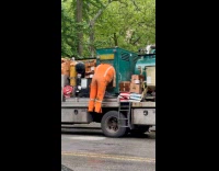 Orange jumpsuit drying hangs at truck generator