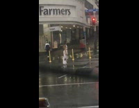 Woman white pants middle street lights rainy
