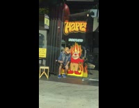 Man in cowboy hat poses with a cartoon art