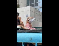 Woman in pink dress pretends to be rabbit