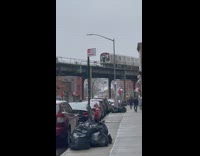 Guy hanging onto the back of subway train