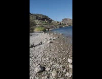 Lady wearing white bikini does headstand beach