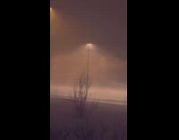 Windy snowstorm weather at night lamp post