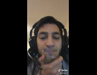 Guy sucksd up seeds with mouth around clear cup