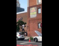 Man walking on stilts across the street 