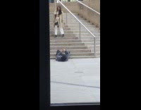Guy laying down photographs girl on stairs