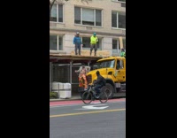 Guy in disco outfit doing dance on bus and workers cheer him on
