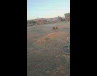 Guy jumps bicycle tries to land on back tire 