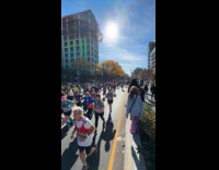 Crowd hand gestures YMCA song at marathon