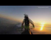 Guy rides jet ski jumps over wave 