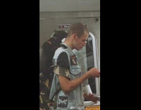 Guy has black cat on backpack on train