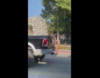 Woman brown beach dress hat pose sidewalk
