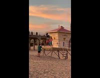 Man and woman tiktok dance on the lifeguard post