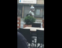 Lady silver jacket zipped up hood on