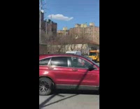 Man rides the bicycle and balances ball on his head