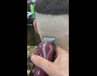 Guy gives straight line haircut to client at barbershop 