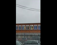 Woman on a treadmill with only the half body seen on the window