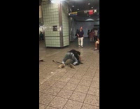 Woman dances on the floor while live band plays guitar and cajon in subway station