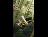 Person sitting on subway train wears a werewolf monster head mask