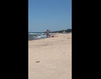 Man shades brief pose on beach seagulls