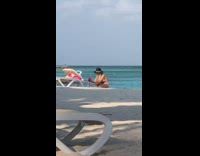 Woman white bikini hat fix tripod beach