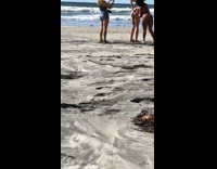 Woman puts baby oil on the butt of the woman