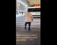 Guy white jacket directs traffic on crosswalk