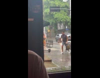 Couple in beach wear poses rainy street Part 2