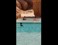 Woman on sunbed poses while man pictures Part 2