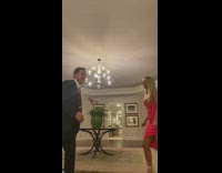 Guy in suit chest bumps girl in red dress and knocks her over 