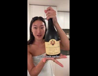 Woman opens expensive wine and gets splashed